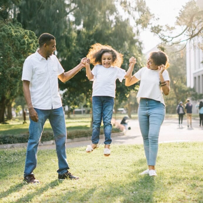 family holding up daughter